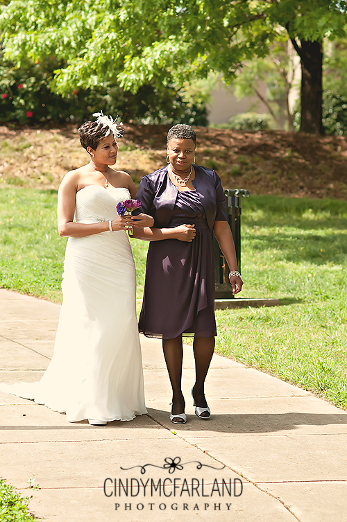 Bride being walked down the aisle by her mother.