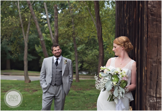 Groom looks lovingly at readheaded bride wearing vintage dress