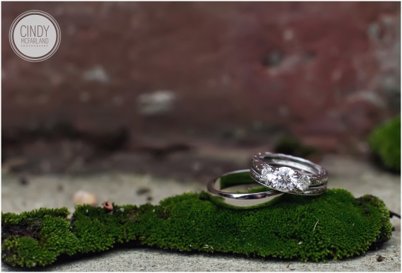 Wedding rings sitting on top of moss