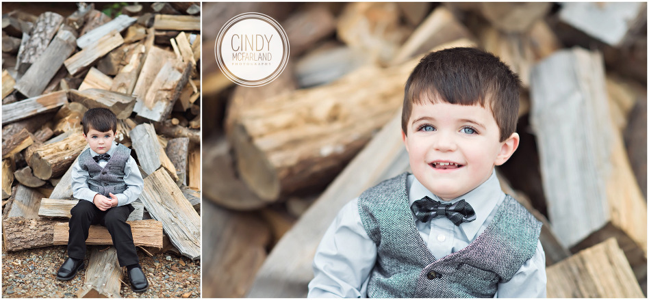 ring bearer in front of wood pile